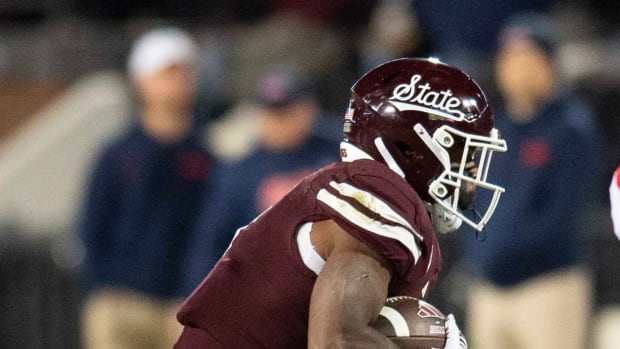 Mississippi State's Marcus Banks (1) gets taken down by LB Jeremiah Jean-Baptiste during a punt return in second half of the Egg Bowl at Davis Wade Stadium in Starkville, Miss.